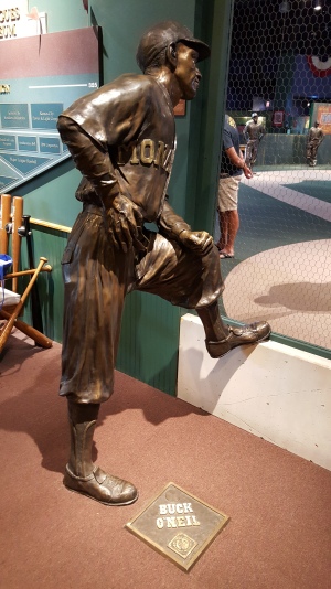At the entrance to the museum, Kansas City baseball icon Buck O'Neil watches over a field of statues of the Negro Leagues' greatest.
